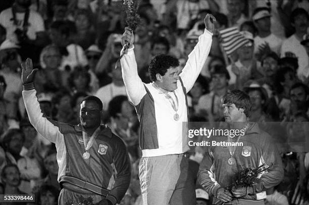 Shown on victory stand in Los Angeles coliseum 8/11 for awards in Men’s Shot Put event are Italy’s Alessandro Andrei , Gold; Michael Carter, Dallas,...