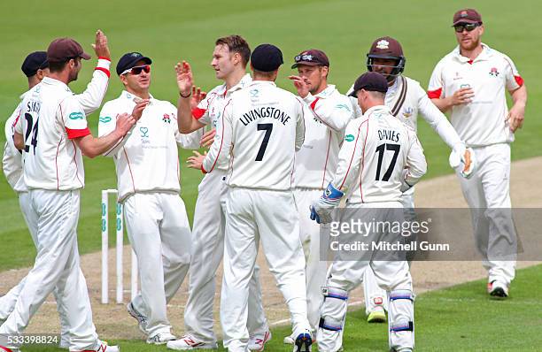 Kyle Jarvis of Lancashire celebrates the wicket of Kumar Sangakara of Surrey during the Specsavers County Championship Division One match between...