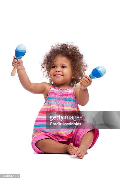 biracial baby girl/ toddler waving her maracus isoltated on white - musical instrument white background stock pictures, royalty-free photos & images