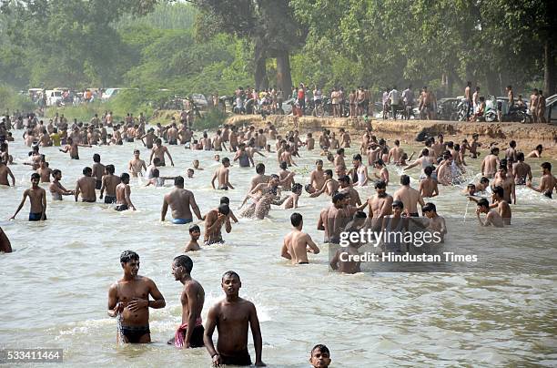 Children enjoy a swimming in Masuri River as Delhi/NCR experienced yet another scorching day, on May 22, 2016 in Ghaziabad, India. Heat waves hit...