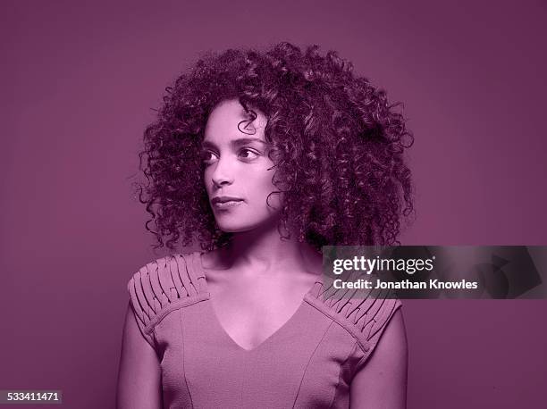 dark skinned female, looking away - purple shirt stock-fotos und bilder