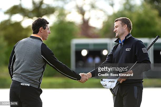 Rory McIlroy of Northern Ireland shakes hands with Russell Knox of Scotland on the 18th green following his victory during the final round of the...
