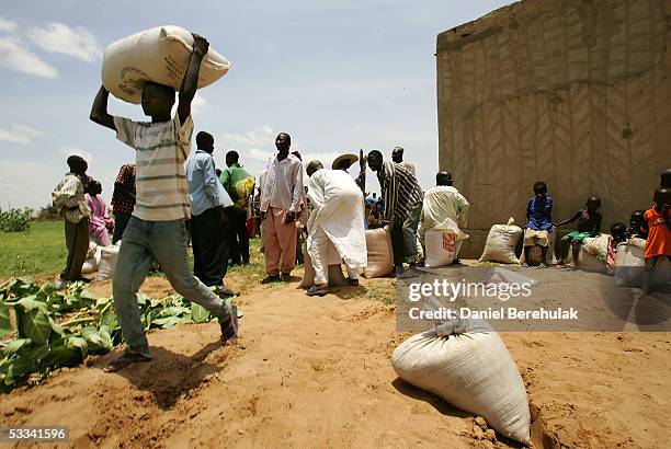 Kg bag of millet is carried by a villager of Douloukou from a distribution centre on August 8, 2005 near Dakoro, Niger. Care International...