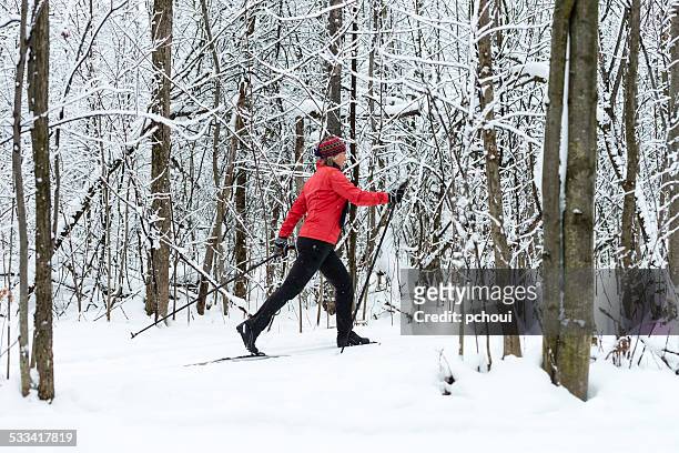woman cross-country skiing, snow, winter sport. - cross country skiing tracks stock pictures, royalty-free photos & images