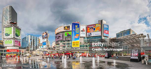 toronto yonge dundas square crowds fountains colourful billboards panorama canada - toronto stock pictures, royalty-free photos & images