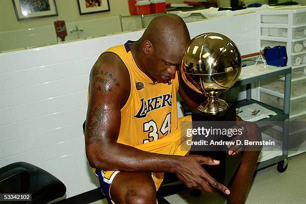 Shaquille O'Neal of the Los Angeles Lakers holds the Playoff MVP Trophy after winning the 2000 NBA Championship against the Indiana Pacers on June...