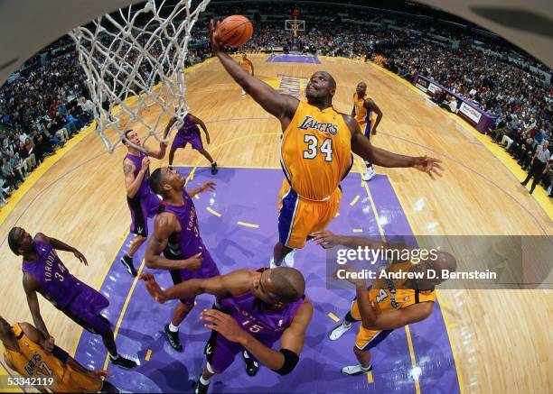 Shaquille O'Neal of the Los Angeles Lakers grabs a rebound against the Toronto Raptors during an NBA game circa 2000 at the Staples Center in Los...