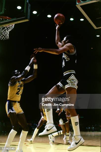 George Gervin of the San Antonio Spurs shoots a jumpshot along the baseline against Michael Cooper of the Los Angeles Lakers during an NBA game circa...