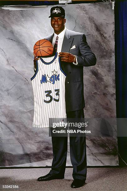 Shaquille O'Neal poses with his new jersey, which was later changed to, after being drafted by the Orlando Magic first overall in the 1992 NBA Draft...