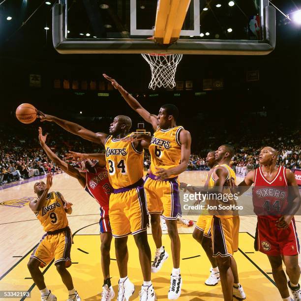 Shaquille O'Neal of the Los Angeles Lakers blocks a shot by Allen Iverson of the Philadelphia 76ers during an NBA game circa 1997 at the Forum in Los...