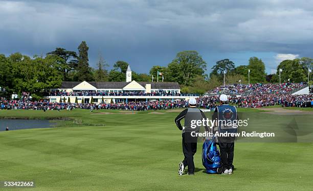 Rory McIlroy of Northern Ireland stands with his caddie JP Fitzgerald on the 18th hole during the final round of the Dubai Duty Free Irish Open...