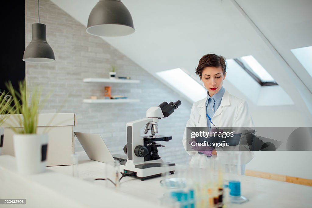 Female Researcher Working In Her Lab.
