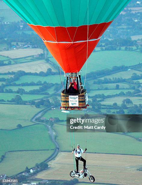 Ian Ashpole prepares to jump from his specially customised chopper-style motorcycle, suspended beneath a hot-air balloon at 3000 feet over the Ashton...