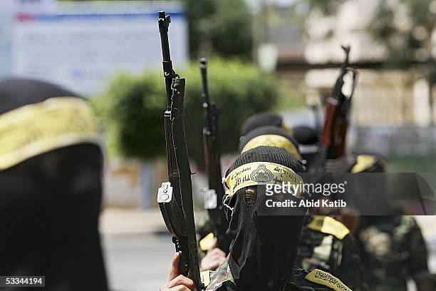 Masked Fatah militants protest outside the Palestinian Legislative building as Mahmoud Abbas holds a parliamentary session on August 9, 2005 in Gaza...