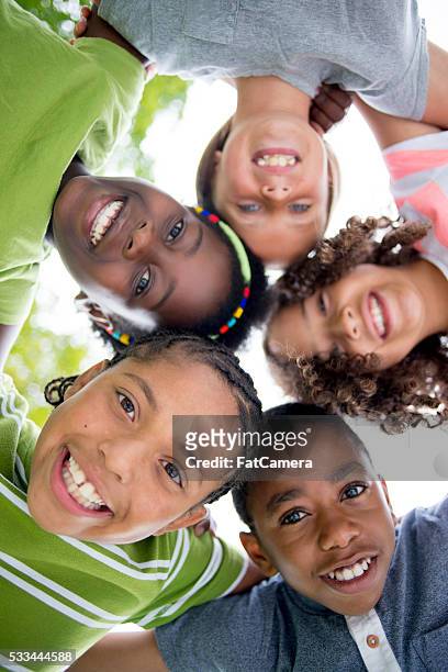 group huddle - children only stock pictures, royalty-free photos & images