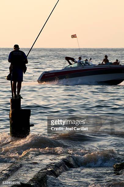 speedboat and fisherman in beirut, lebanon - surf casting stock pictures, royalty-free photos & images