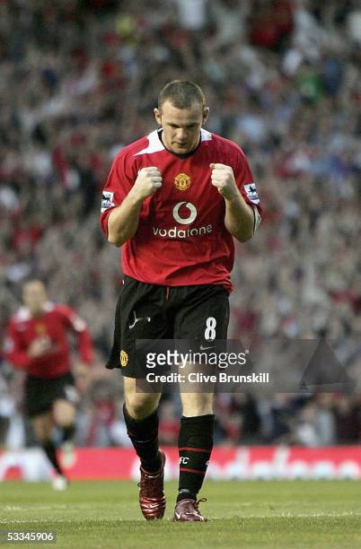 Wayne Rooney of Manchester United celebrates scoring the first goal during the Champions League third qualifying round, first leg match between...