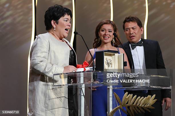 Filipino actress Jaclyn Jose delivers a speech next to Filipino actress Andi Eigenmann and Filipino director Brillante Mendoza after being awarded...