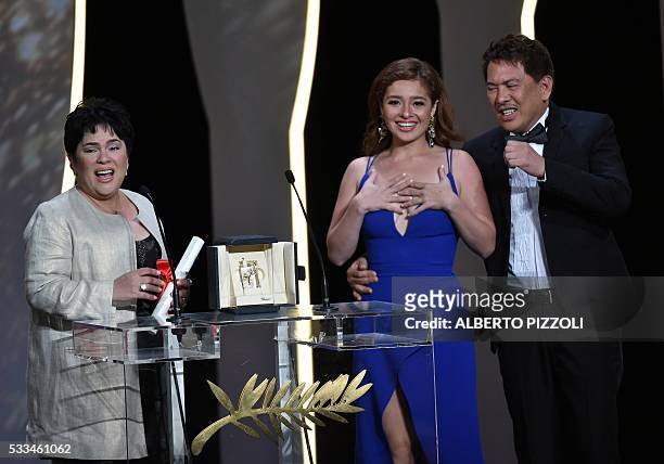 Filipino actress Jaclyn Jose celebrates on stage next to her daughter, Filipino actress Andi Eigenmann, and Filipino director Brillante Mendoza after...
