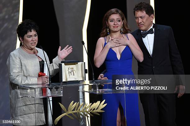 Filipino actress Jaclyn Jose celebrates on stage next to her daughter, Filipino actress Andi Eigenmann, and Filipino director Brillante Mendoza after...