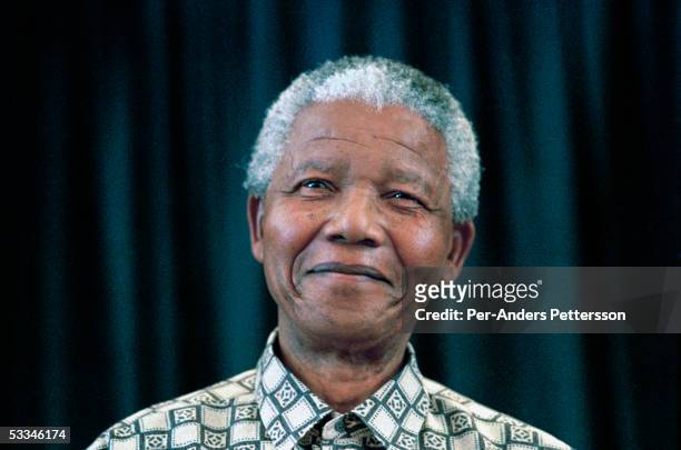 Former President Nelson Mandela of South Africa speaks to visitors on March 8, 1999 in his residence in Houghton, a suburb of Johannesburg, South...
