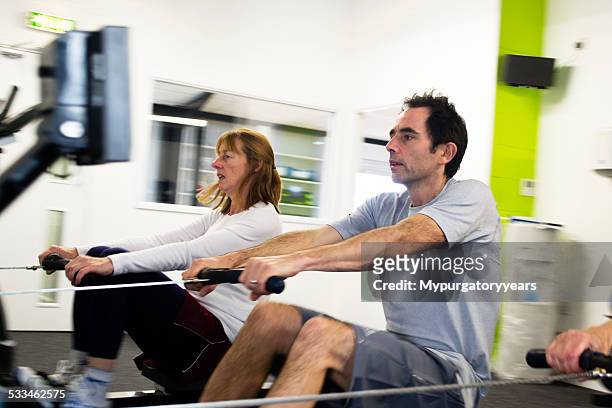 rowing in the gym - peloton tread stock pictures, royalty-free photos & images