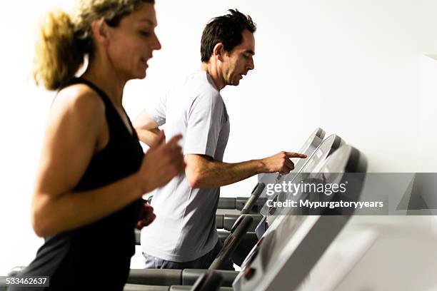 using the treadmill - peloton tread stock pictures, royalty-free photos & images