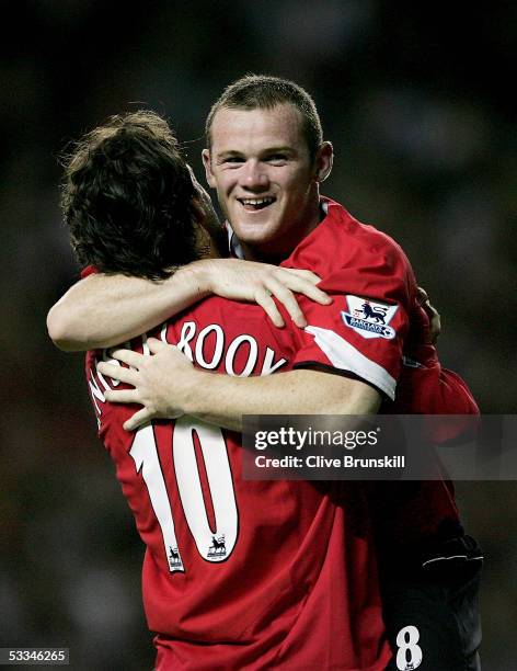 Wayne Rooney and Ruud Van Nistelrooy of Manchester United celebrate Ronaldos third goal during the Champions League third qualifying round, first leg...