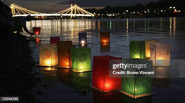 Monk from the Nipponzan Myohoji order releases one of 61 lanterns into the River Thames, August 9, 2005 in London. The US B-29 superfortress Bockscar...