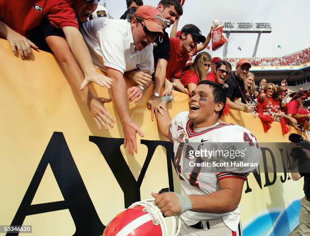 David Pollack of the Georgia Bulldogs high fives fans following the Outback Bowl game against the Wisconsin Badgers at Raymond James Stadium on...