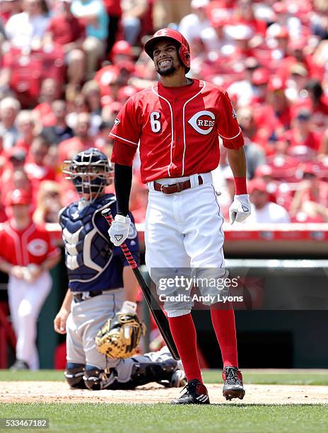 Billy Hamilton of the Cincinnati Reds grimaces after being hit by a pitch in the first inning against the Seattle Mariners at Great American Ball...