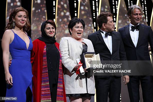 Filipino actress Jaclyn Jose poses on stage with her daughter Filipino actress Andi Eigenmann , Iranian producer and member of the Jury Katayoon...