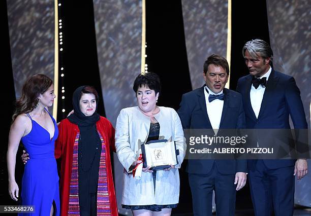 Filipino actress Jaclyn Jose poses on stage with her daughter Filipino actress Andi Eigenmann, Iranian producer and member of the Jury Katayoon...