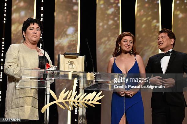 Jaclyn Jose reacts on stage as her daughter Andi Eigenmann and director Brillante Mendoza look on after being awarded the Best Actress prize for the...