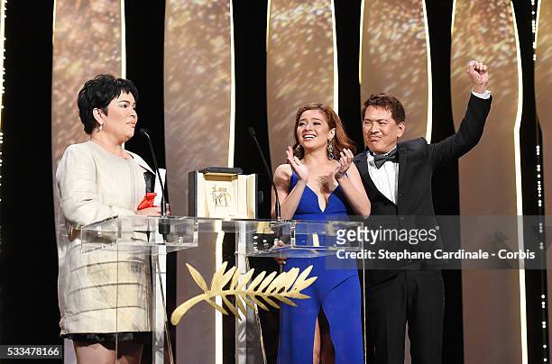 Jaclyn Jose reacts on stage as her daughter Andi Eigenmann and director Brillante Mendoza applaud after being awarded the Best Actress prize for the...