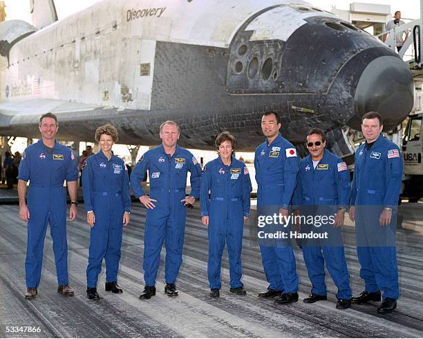 In this handout from NASA, The crew of mission STS-114 Mission Specialist Stephen Robinson, Commander Eileen Collins, Mission Specialists Andrew...