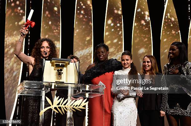 French Moroccan director Houda Benyamina acknowledges applause after being awarded with the Camera d'Or with the cast of her film 'Divines' during...