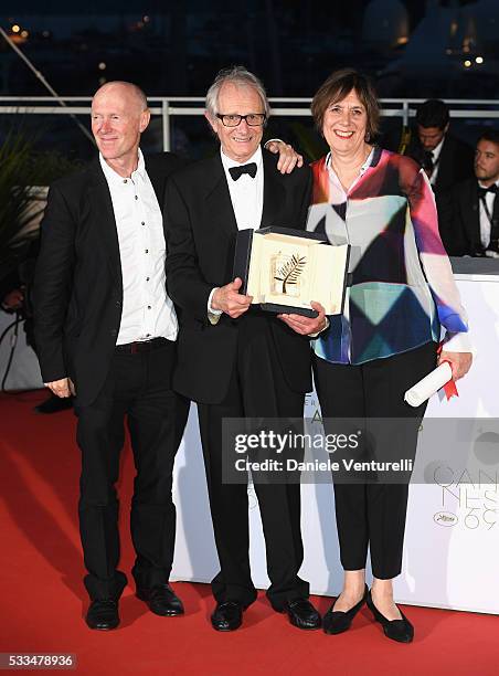 Director Ken Loach poses on stage with screenwriter Paul Laverty and producer Rebecca O'Brien after being awarded the Palme d'Or for the movie 'I,...