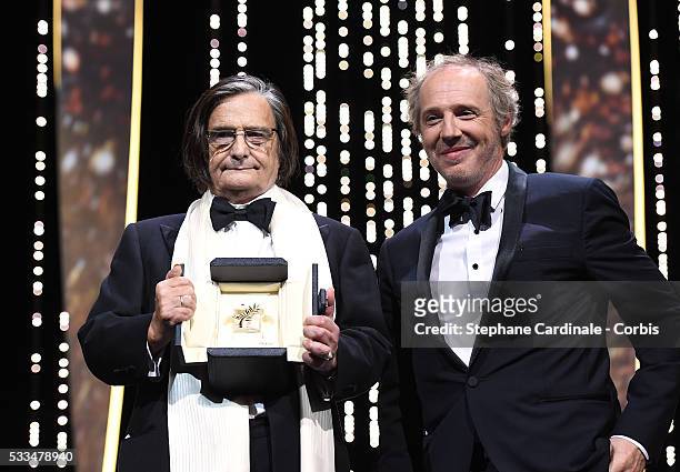 French actor Jean-Pierre Leaud poses with member of the Jury Arnaud Desplechin after being awarded with the honourary Palme d'Or during the Closing...