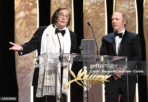 French actor Jean-Pierre Leaud poses with member of the Jury Arnaud Desplechin after being awarded with the honourary Palme d'Or during the Closing...