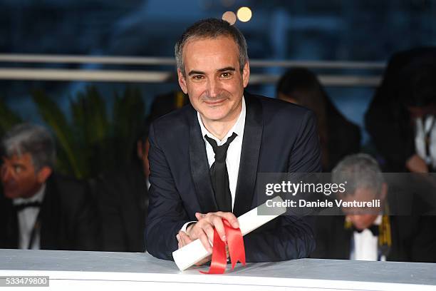 Director Olivier Assayas poses after being awarded the Best Director prize for the movie 'Personal Shopper' during the Palme D'Or Winner Photocall...