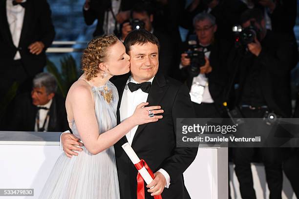 Actress Maria Dragus kisses Romanian director Cristian Mungiu for winning the Best Director prize for the film 'Graduation ' at the Palme D'Or Winner...