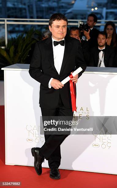 Romanian director Cristian Mungiu, winner of the Best Director prize for the film 'Graduation ', poses at the Palme D'Or Winner Photocall during the...
