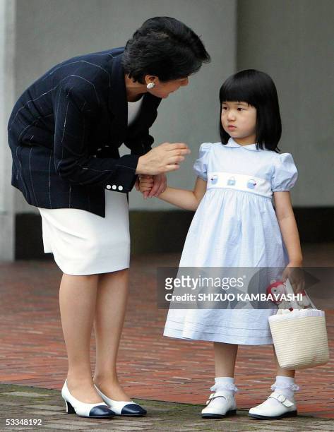 Japan's Crown Princess Masako chats with Princess Aiko upon arrival with Crown Prince Naruhito at Nasushiobara station, north of Tokyo, 10 August...