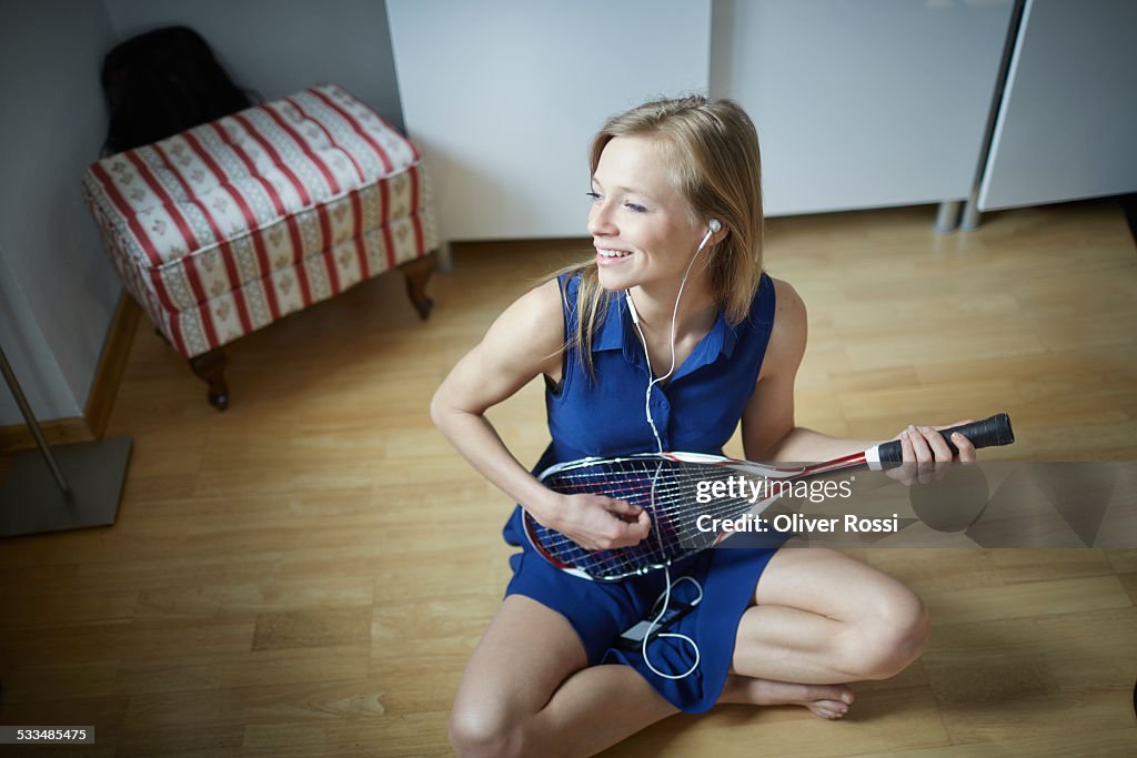 Playful young woman listening to music