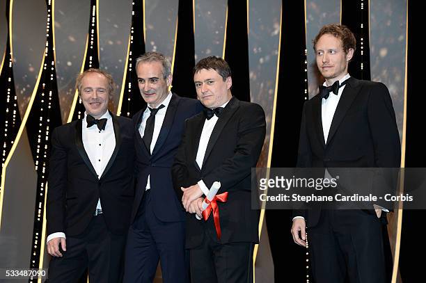 French director Olivier Assayas and Romanian director Cristian Mungiu pose on stage with members of the Jury Arnaud Desplechin Laszlo Nemes after...