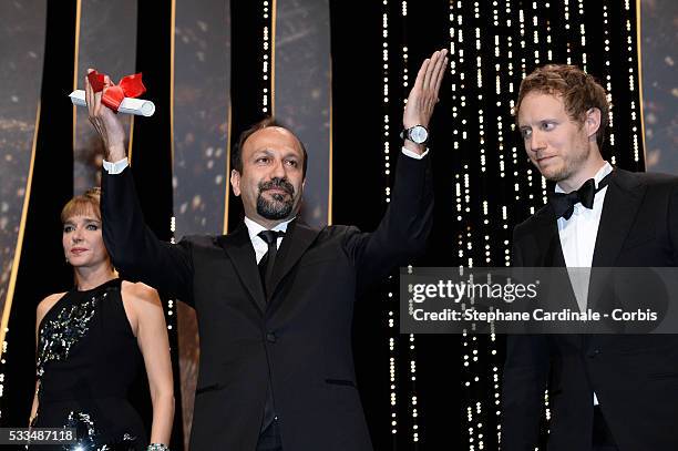 Iranian director Asghar Farhadi celebrates on stage after being awarded with the Best Screenplay prize for the film 'The Salesman ' during the...