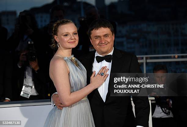 Romanian director Cristian Mungiu poses with Romanian actress Maria Dragus after he was awarded with the Best Director prize for the film "Graduation...