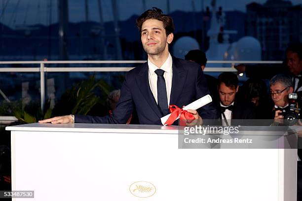 Director Xavier Dolan poses with The Grand Prix for the movie 'Just the end of the world' at the Palme D'Or Winner Photocall during the 69th annual...