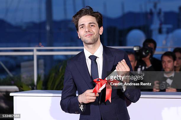 Director Xavier Dolan poses with The Grand Prix for the movie 'Just the end of the world' at the Palme D'Or Winner Photocall during the 69th annual...